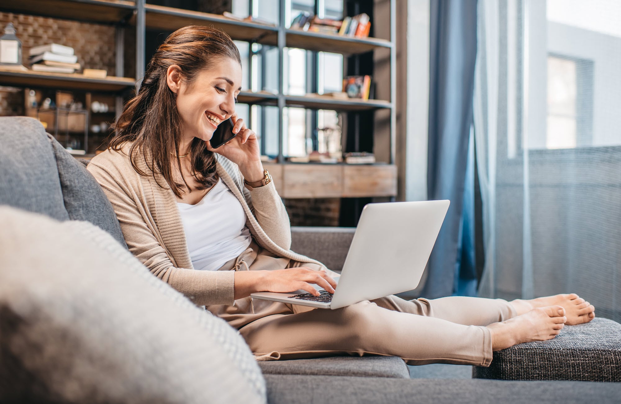 Woman on laptop selecting the right business at home insurance.